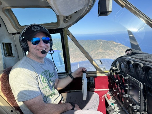 Dr. Jonathon White flying a light aircraft